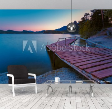 Picture of Wooden pier on a blue lake sunset and smooth reflection on water Long exposure Borovoye Lake Kazakhstan